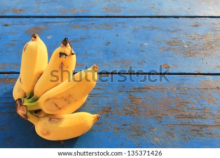 Bunch of bananas on the old blue table