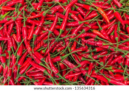 The Picture Shows A Pile Of Small, Red, Very Hot And Spicy Chilli Peppers On An Asian Market.