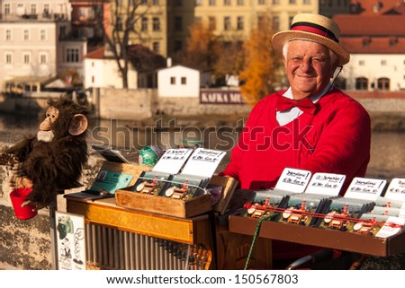 PRAGUE, CZECH REPUBLIC, - SEPTEMBER 7:  Man offers music from hand operated music box in exchange for money on Charles Bridge on September 7, 2012 in Prague, Czech Republic