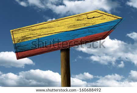Colombia flag wooden sign with a beautiful sky on background - Latin America