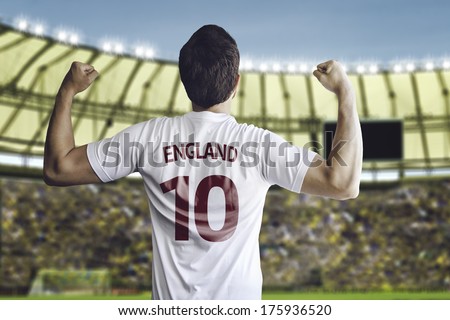 English soccer player celebrates with the fans on the stadium