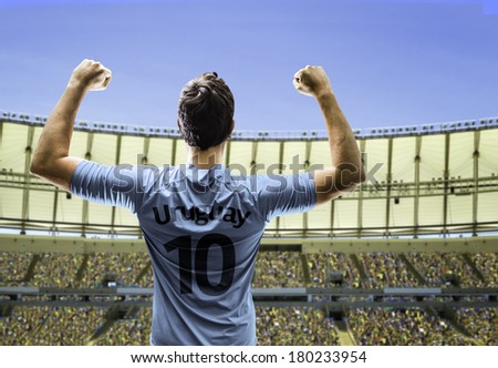 Uruguayan soccer player celebrates with the fans on the stadium