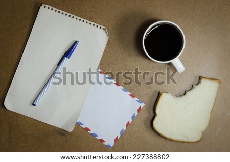 cup of coffee , rich and soft sliced bread,paper note