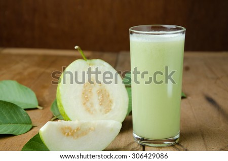 Guava juice and fresh Guava on wooden background