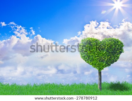 A tree formed like a hart in front of a beautiful sunny sky
