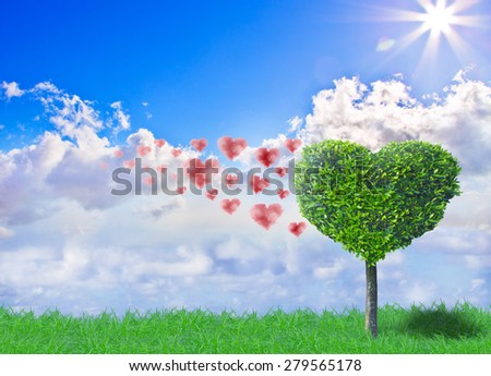 Tree formed like a heart in front of a beautiful sky with hearts as clouds