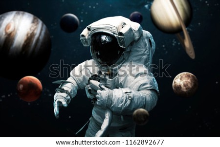 Astronaut and all planets of Solar system. Science fiction art. Elements of this image furnished by NASA