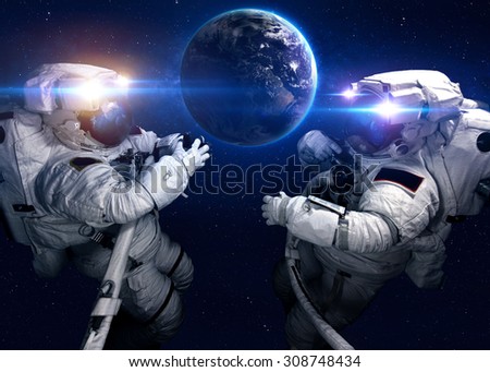 Astronaut in outer space against the backdrop of the planet. Elements of this image furnished by NASA.