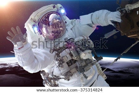 Astronaut in space over the planet Earth. Elements of this image furnished by NASA