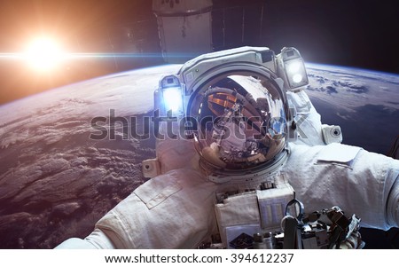 Astronaut in outer space against the backdrop of the planet earth. Elements of this image furnished by NASA