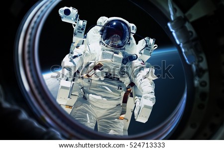 Earth planet and astronaut in space ship window porthole. Elements of this image furnished by NASA