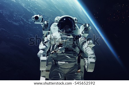 Astronaut at spacewalk. Cosmic art, science fiction wallpaper. Beauty of deep space. Billions of galaxies in the universe. Elements of this image furnished by NASA