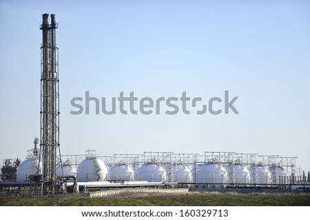 Gas storage tanks in petrochemical plant with clear sky on background