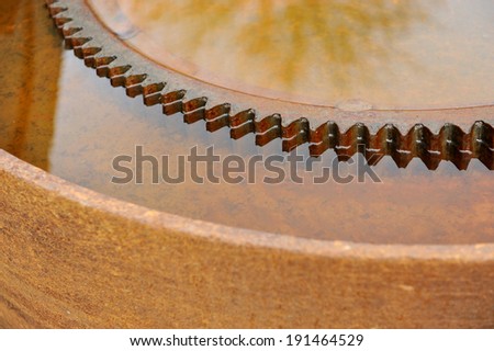 Detail with a rusty industrial sprocket wheel