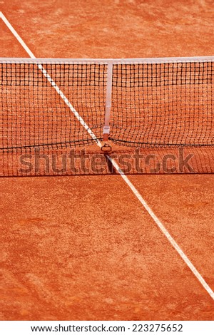 Tennis net detail on a clay court