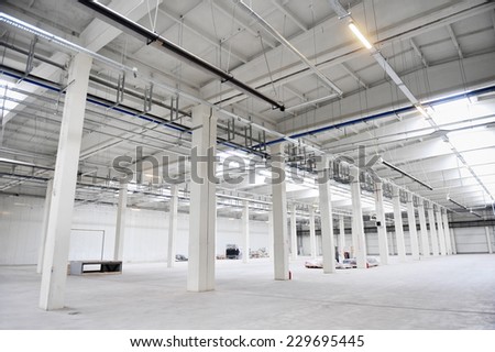 Interior detail with an empty industrial storage depot with ceiling heating system