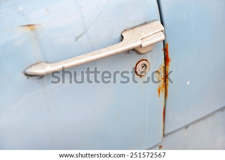 Detail shot with a rusty door lock from an old car