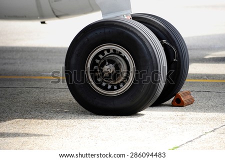 Detail shot with big airplane wheels and landing gear