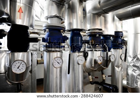 Industrial shot with a manometers and heating pipelines inside a water heating station