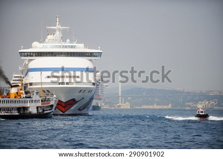 ISTANBUL/TURKEY - JUNE 18: Big cruise passenger ship sailing across the Bosphorus strait on June 18, 2014 in Istanbul.