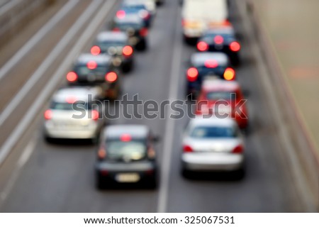 Blur shot of urban rush hour scene with multiple cars in a traffic congestion