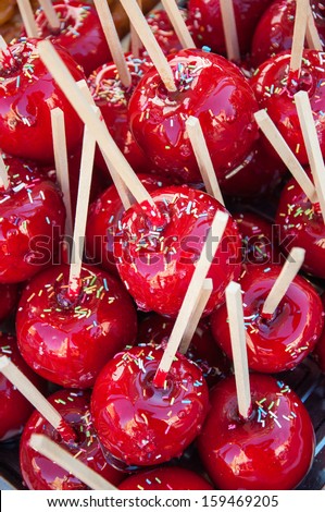 Candied apples with wooden sticks and sprinkles