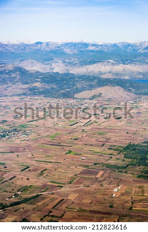 Aerial view of a rural landscape - a rural landscape with mountains in the back