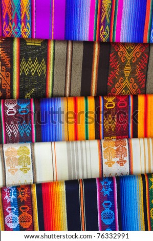 Collection of traditional textiles in ethnic craft market, Ecuador