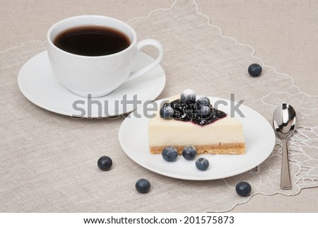 Cheese Cake With Blueberry Jam And Blueberries On White Plate.