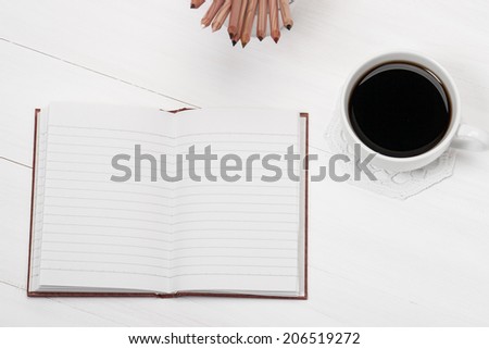 Notebook Mock Up And Cup Of Coffee On White Painted Wooden Desk.