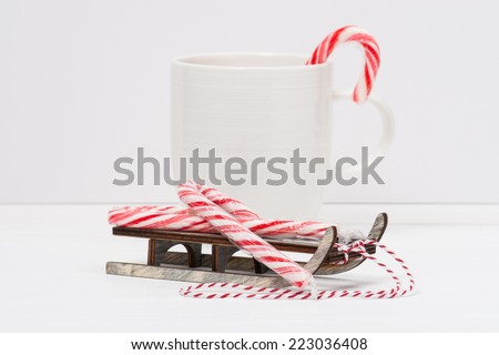 Christmas Candy Cane On Wooden Sledge. White Painted Wood Background.