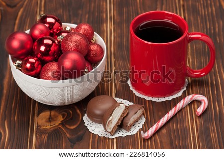 Mug Of Tea Or Coffee. Sweets. Christmas Decorations. Red Balls And Bells. Wooden Background.