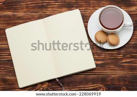 Open Notepad. Cup Of Tea. Macaroon Cookies. Wooden Background.