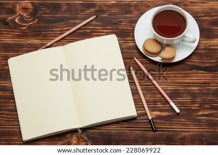Open Notepad. Cup Of Tea. Macaroon Cookies. Wooden Background.