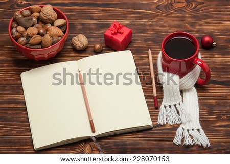 Open Notepad. Mug Of Tea With Scarf. Wooden Background.