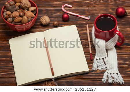 Open Notepad. Mug Of Tea With Scarf. Wooden Background.