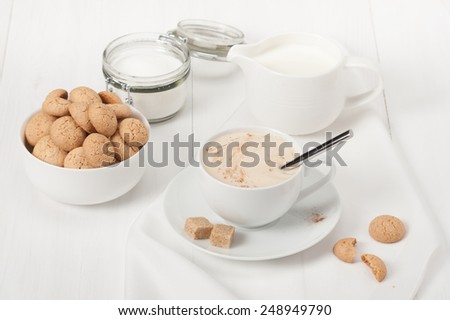 Amaretti Biscuits. Cup Of Cappuccino Coffee. Lump Demerara Sugar.
