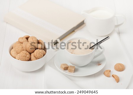 Amaretti Biscuits. Cup Of Cappuccino Coffee. Lump Demerara Sugar. Book With Handmade Textile Cover.