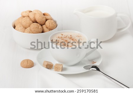 Amaretti Biscuits. Cup Of Cappuccino Coffee. Lump Demerara Sugar.
