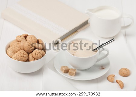 Amaretti Biscuits. Cup Of Cappuccino Coffee. Lump Demerara Sugar. Book With Handmade Textile Cover.