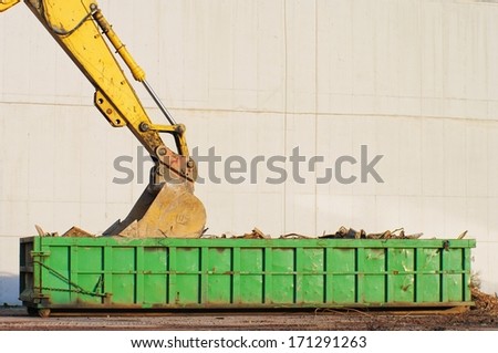 Development concept: Machinery and dumpster at work site.