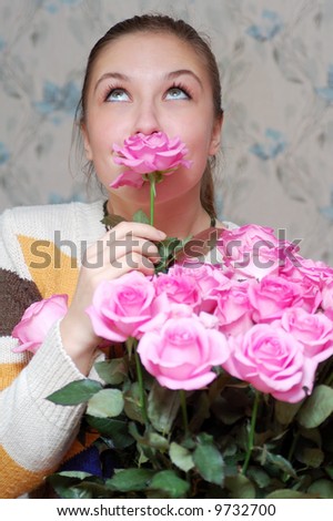 happy girl smelling a flower from big bouquet and dreaming
