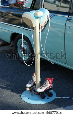 A closeup of american style drive-in movie speakers with rollerskates.