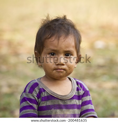 Bardia, Nepal - November 25, 2013 : Unidentified young nepali boy portrait with dirty face in Bardia, Nepal, 2013