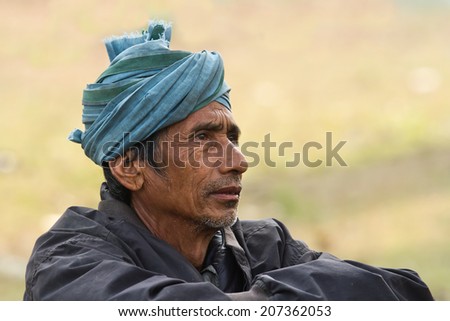 Bardia, Nepal - December 13, 2013 : Portrait of nepali taru man wearing turban in Bardia, Nepal