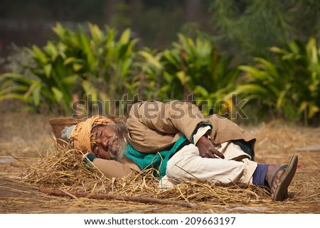Bardia, Nepal - January 15, 2014: Very old poor taru man sleeping on the floor in Bardia, Nepal