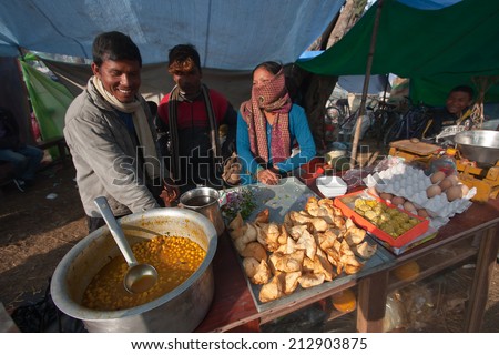 Bardia, Nepal - January 16, 2014: Street seller cooking nepali local food during Maggy festival fair in Bardia, Nepal
