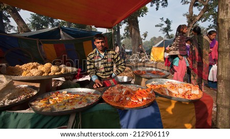 Bardia, Nepal - January 16, 2014: Nepali pastries and sweet street seller during Maggy festival fair in Bardia, Nepal