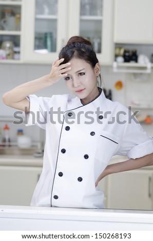 Asian female chef in chef whites uniform