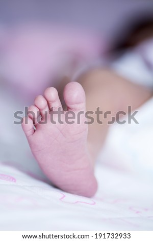 close up of Little baby feet with mother hand, baby is a asian